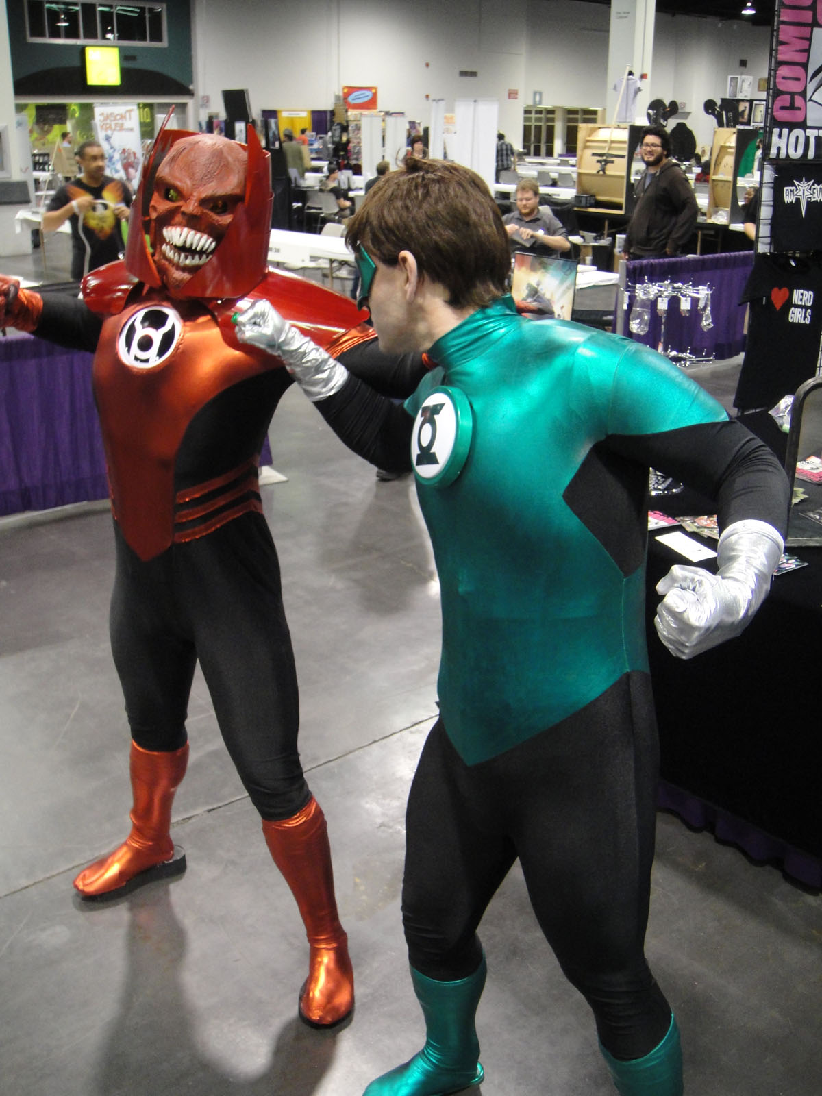 two people in costumes dressed like superheros pose for the camera