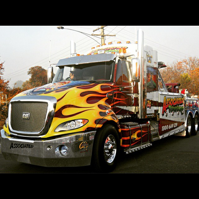 a big truck with flaming flames painted on the side