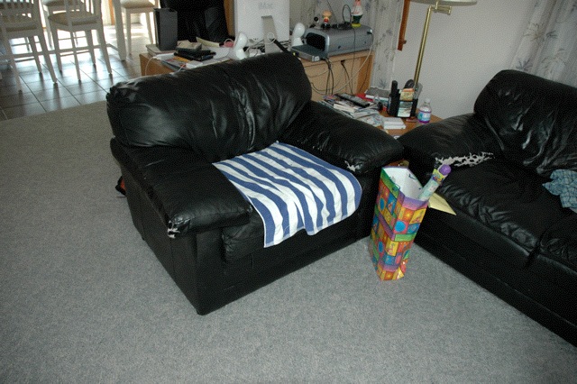 black leather couches and chairs in living room