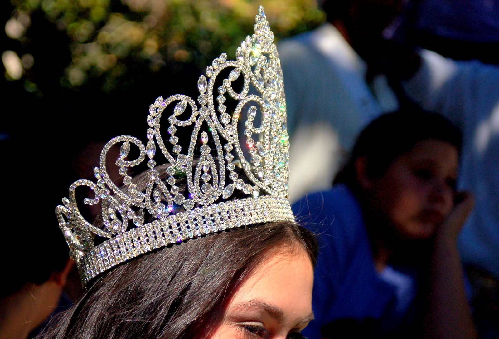 the young woman in the tiara looks back
