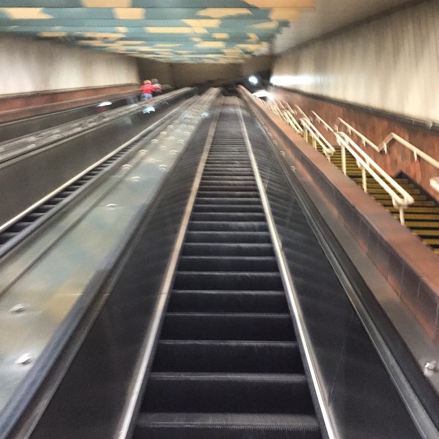 looking down from the escalator to the platform