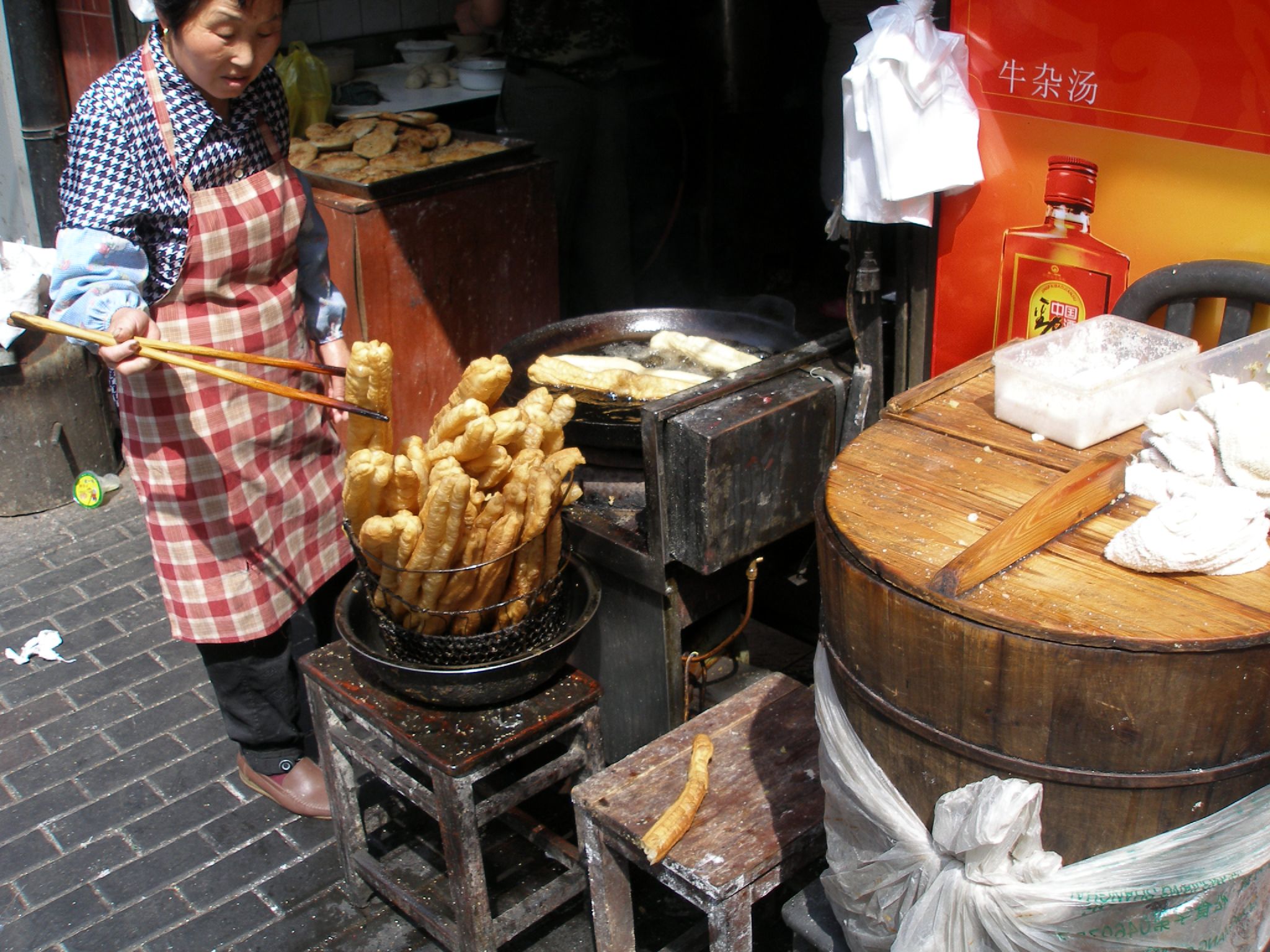 a person standing over some food in a bucket