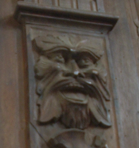 the face of a man carved into the side of a building