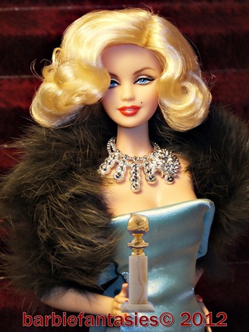 a blond barbie doll wearing a very long evening dress