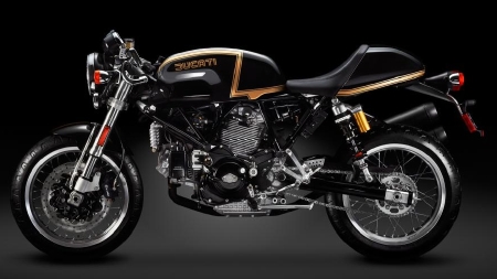 a black and gold motorcycle parked in the dark