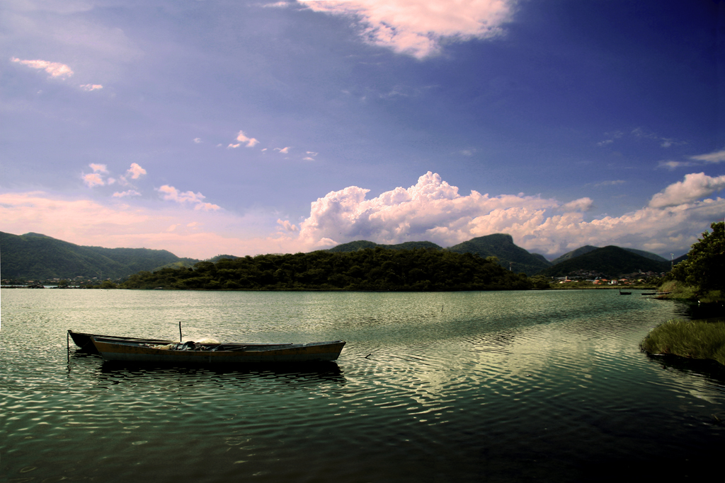 two canoes on a lake with a mountain range in the background