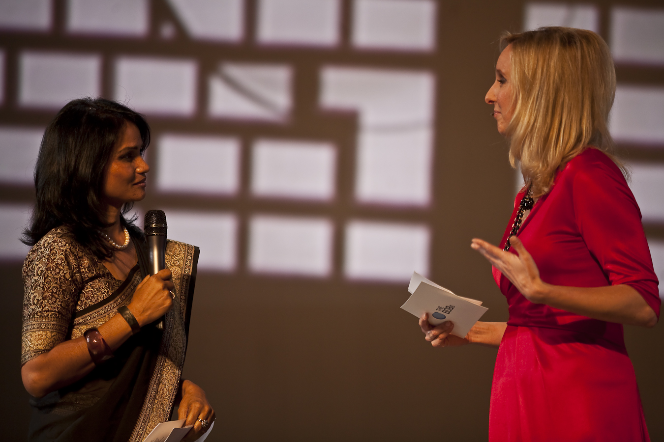 two women at a conversation with a microphone