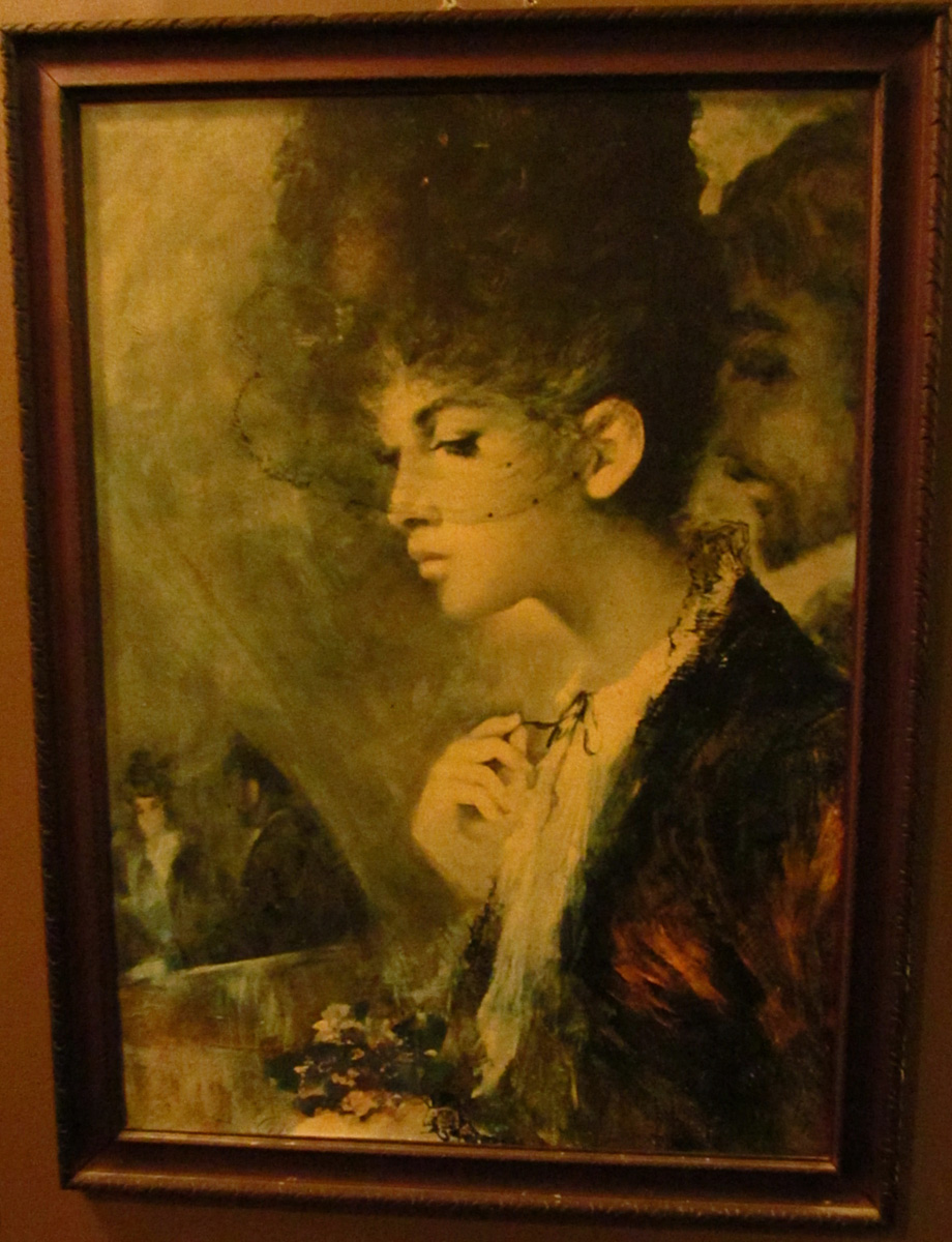 a framed painting that has a woman in it