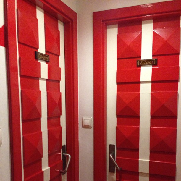 two red and white doors inside of a building