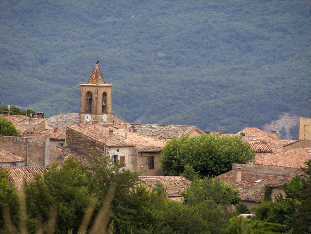 a village with towers and chimneys is situated in the foreground