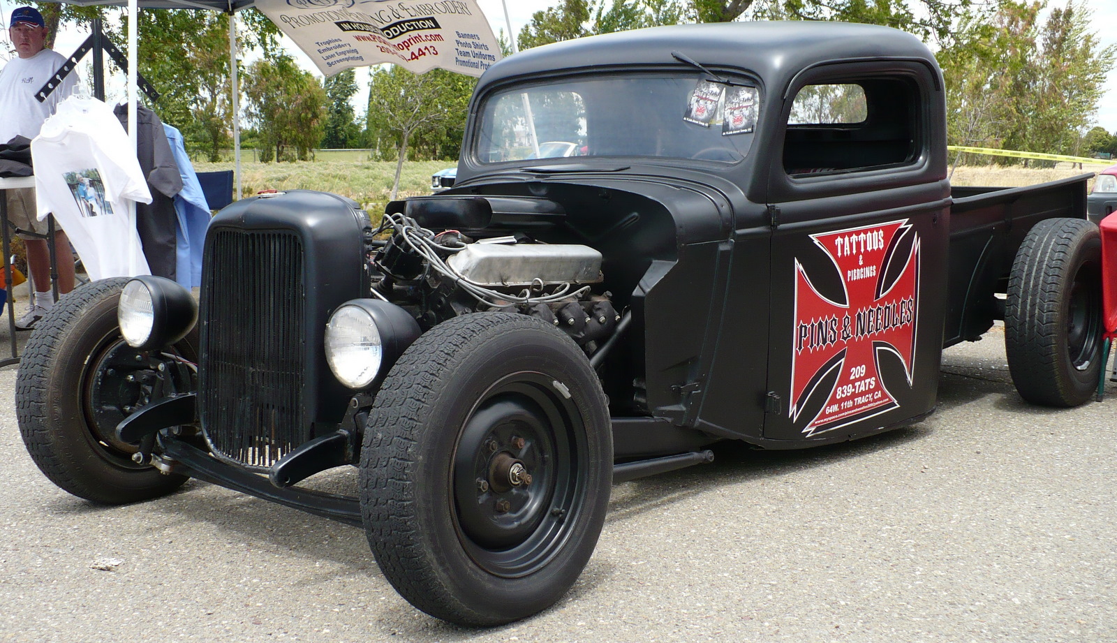 an old black car with flames on the hood