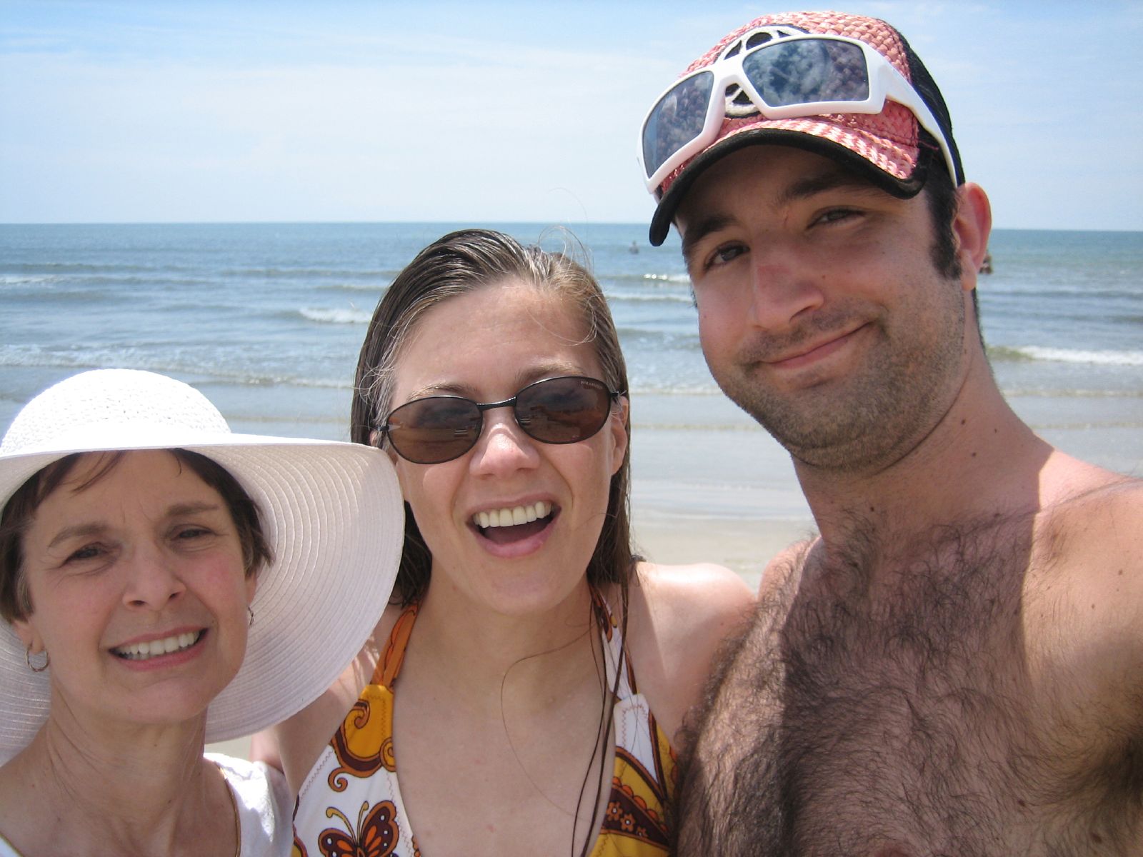 a man and two women on the beach