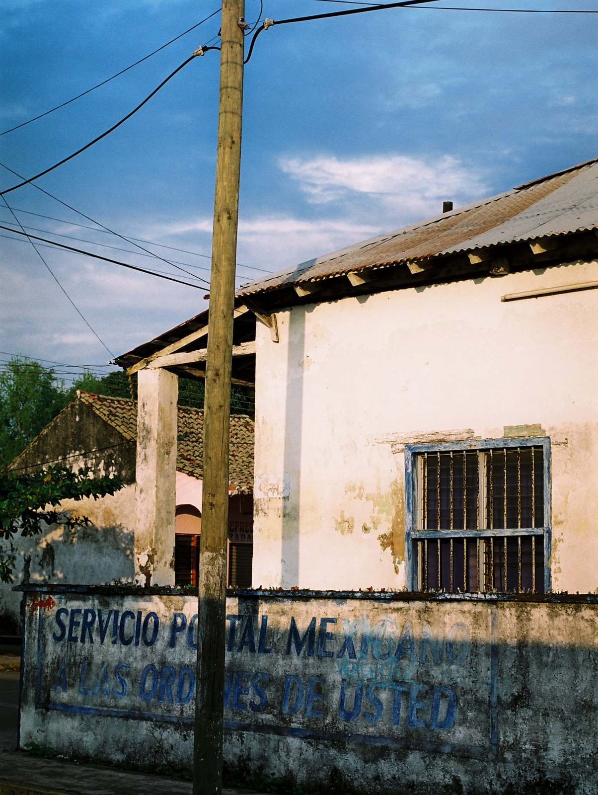 a building with graffiti on the side and a street lamp above