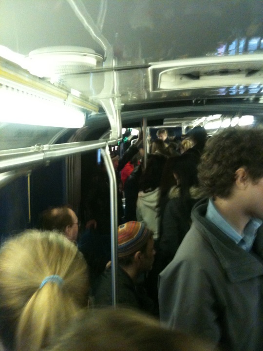 a crowded subway car with people all together