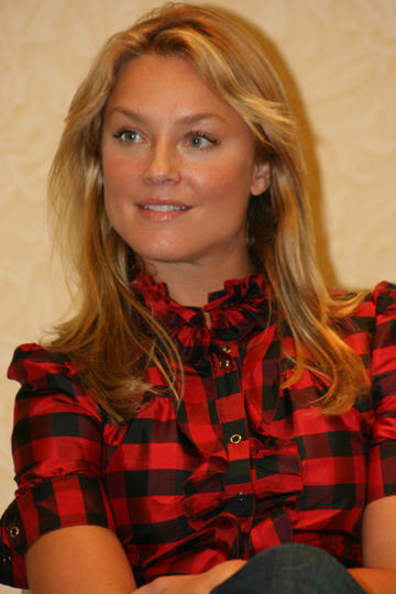 a woman wearing red and black plaid shirt sitting down