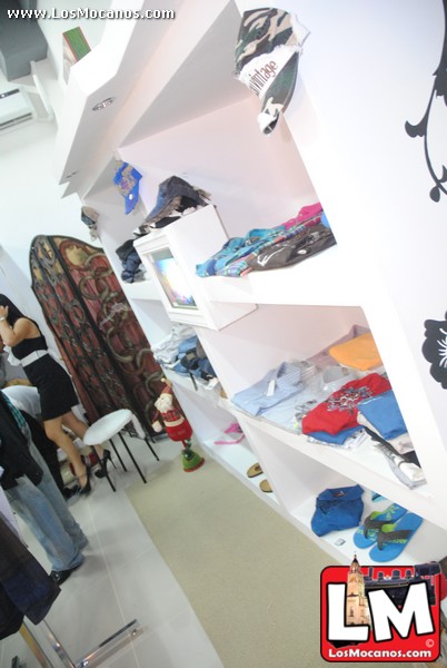 people are looking at their clothes inside a room