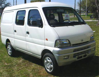 a white van parked in a grass field
