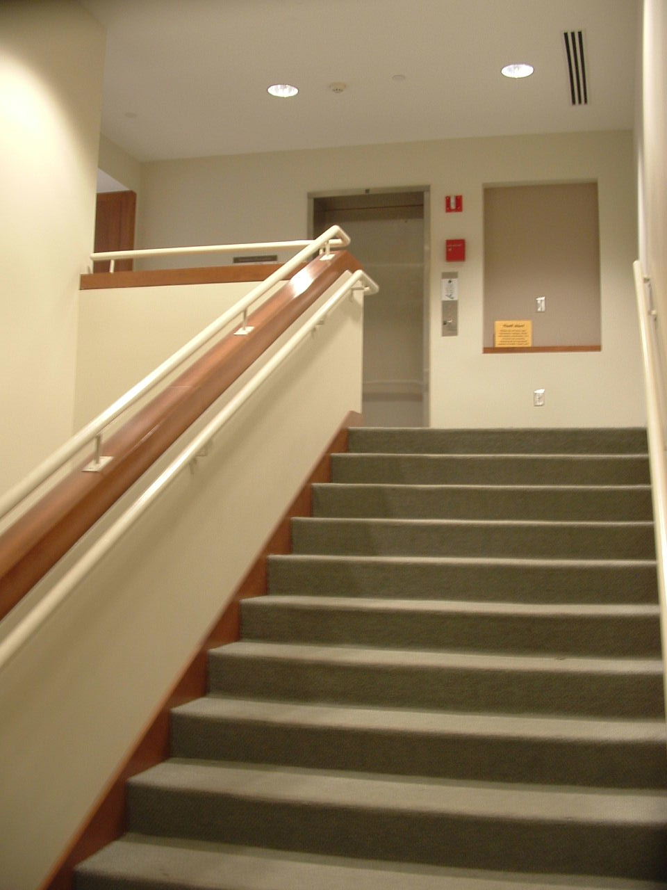 an empty staircase with a small white fire hydrant