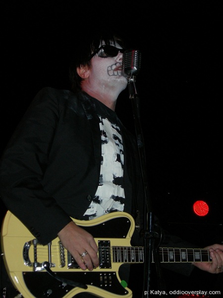 man in black jacket playing an electric guitar