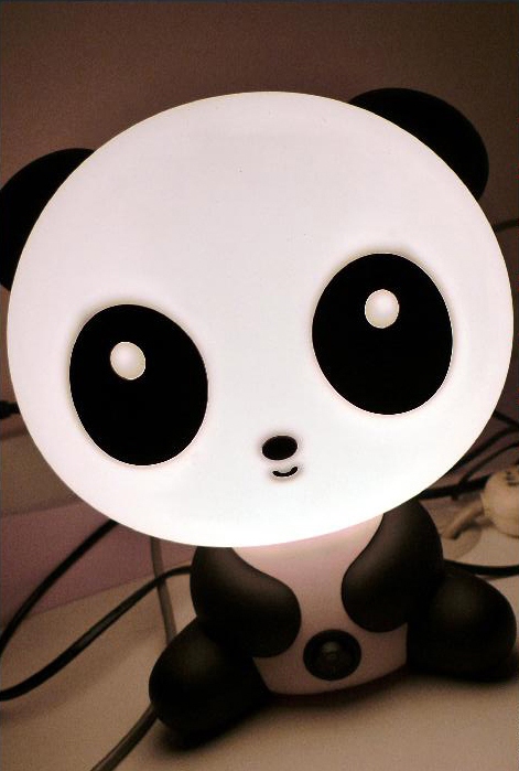 a panda bear lamp that has one eye visible