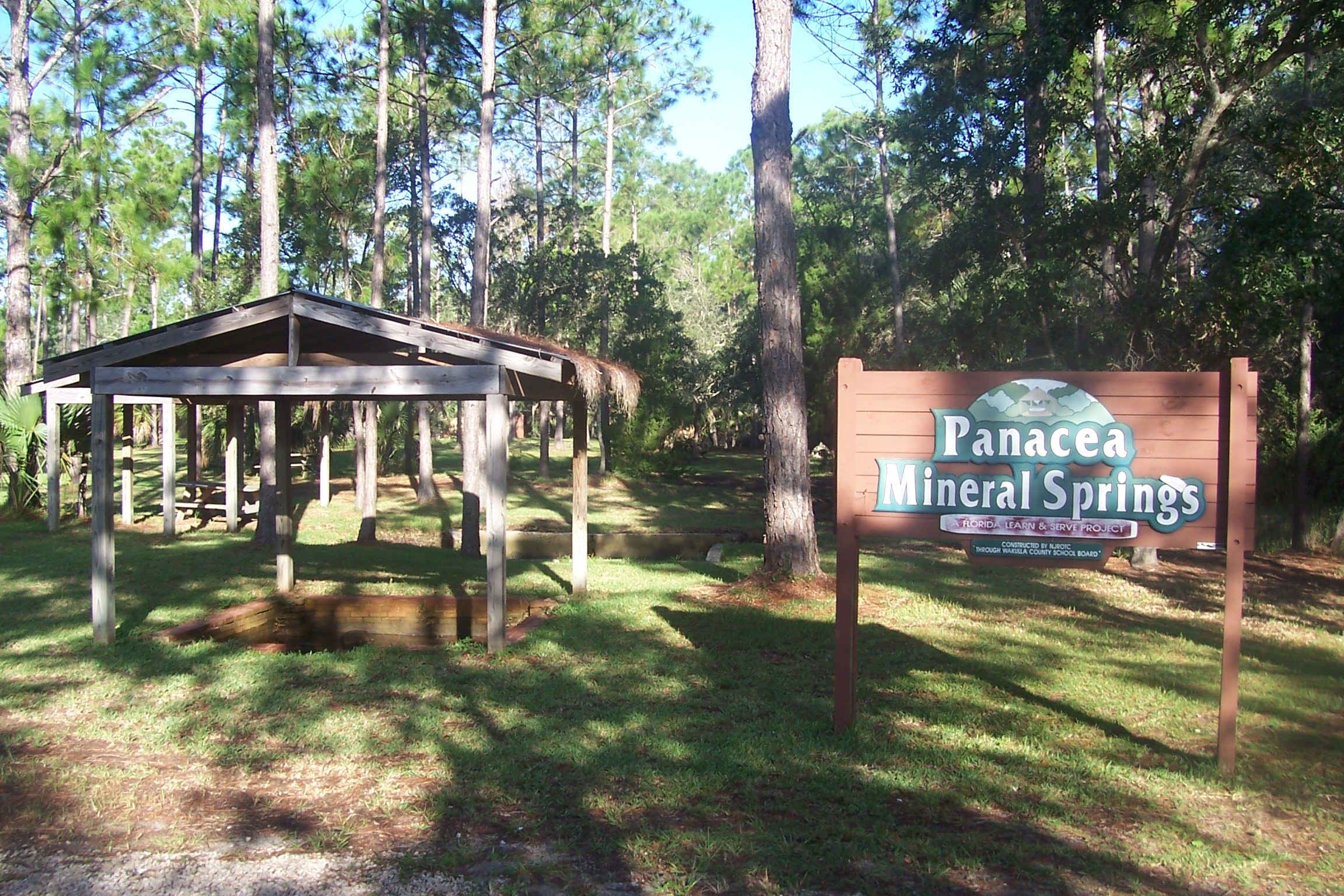 the entrance to a wooded park with signage for kanbea, michael sings