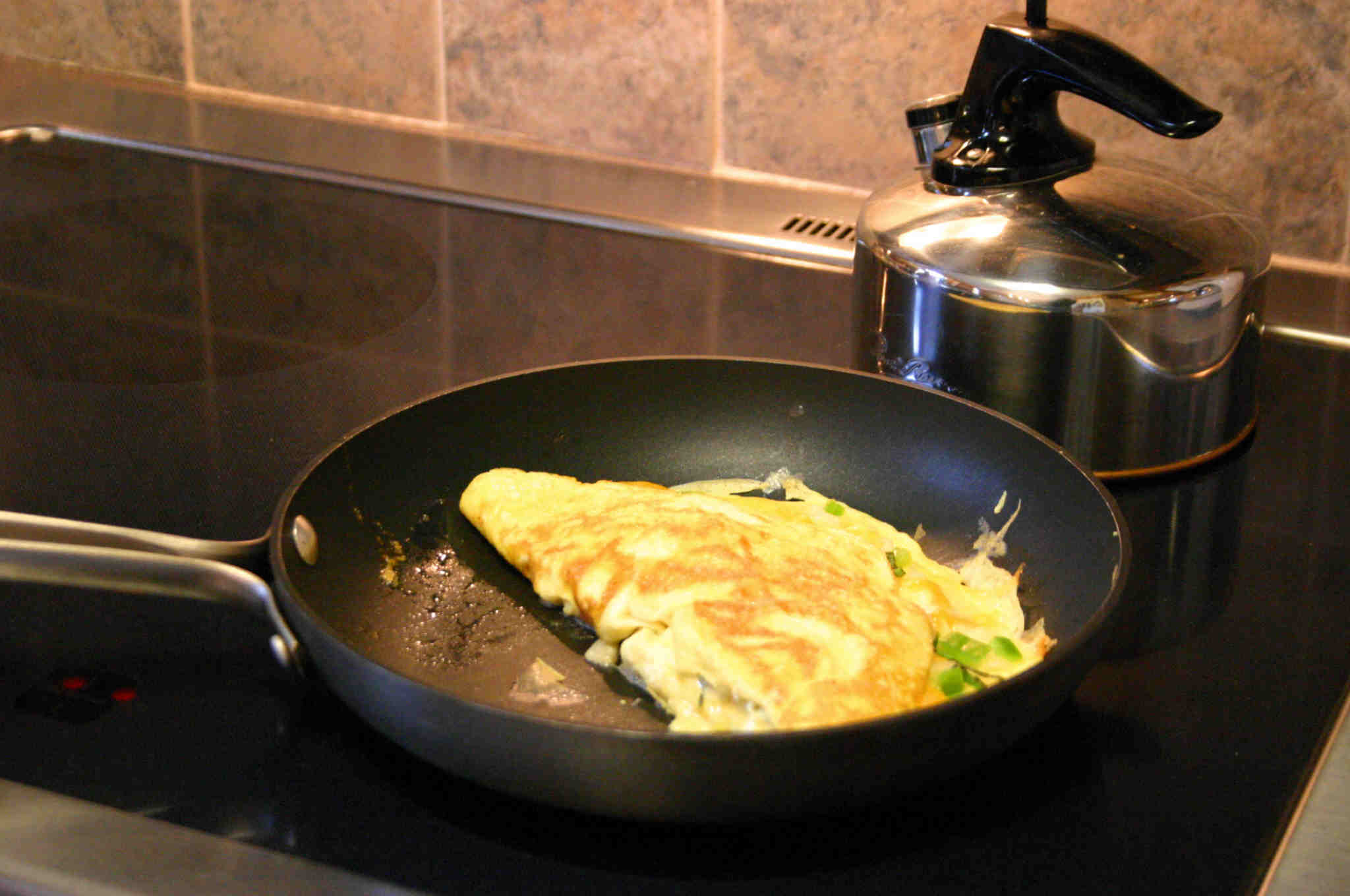 the set has a large pan with an omelet on it