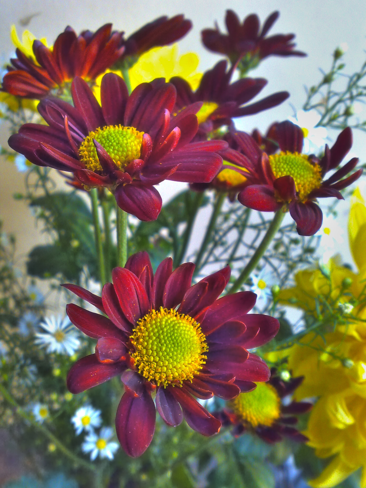 some flowers that are in the vase on a table