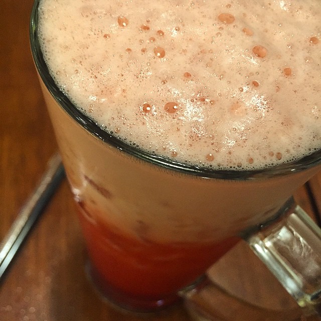 a mug filled with some type of food next to a plate