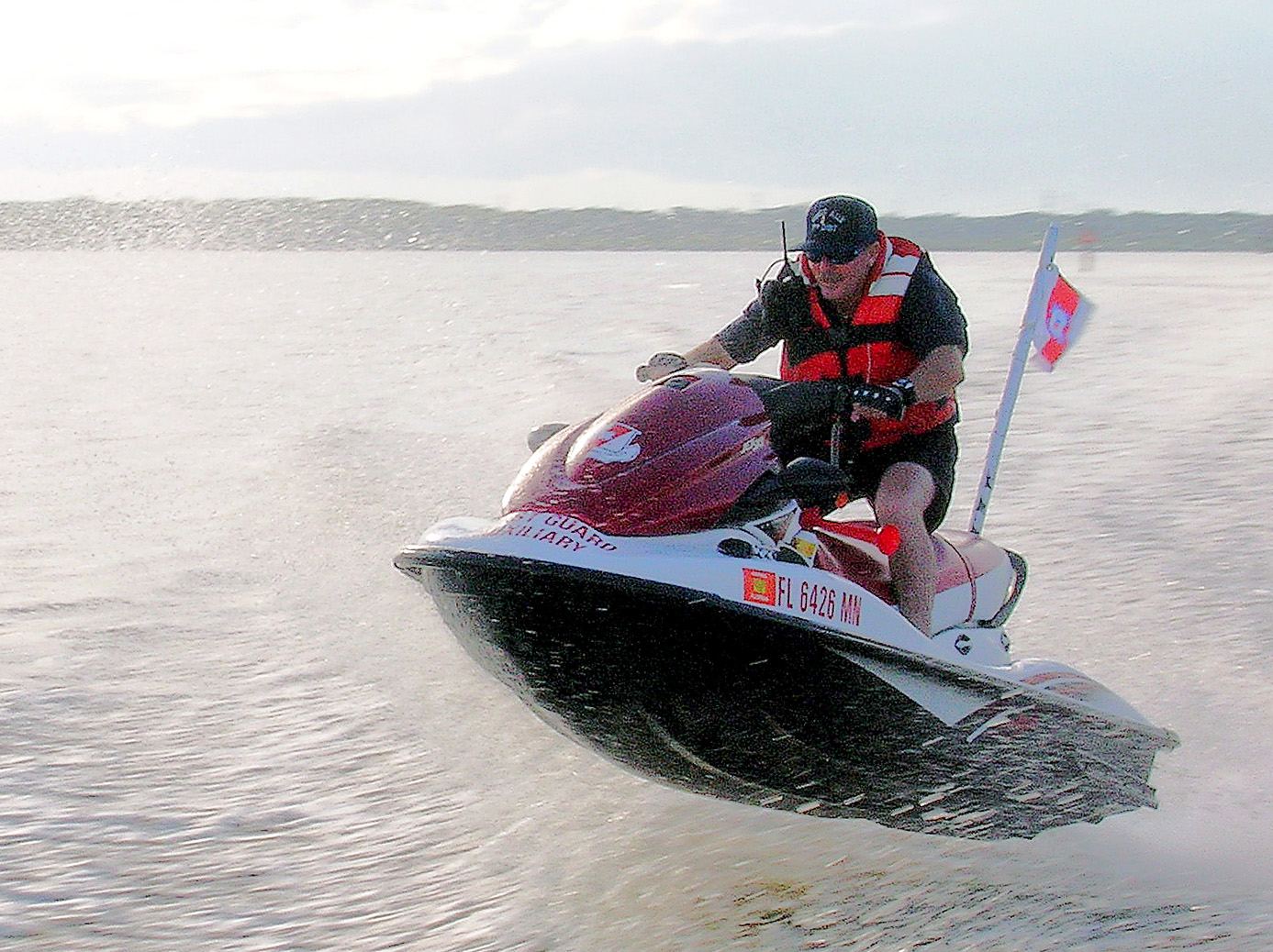 a man rides on top of a black and white water ski