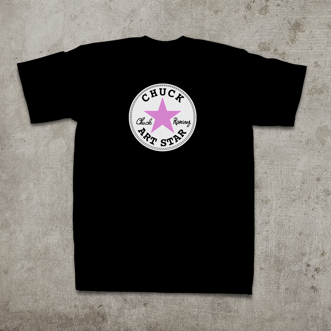 a shirt on a gray surface with pink star