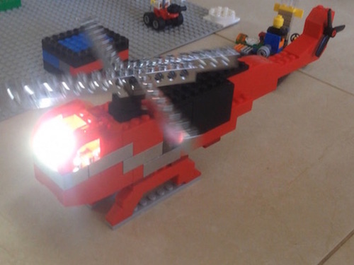 toy fire truck with lego parts around it