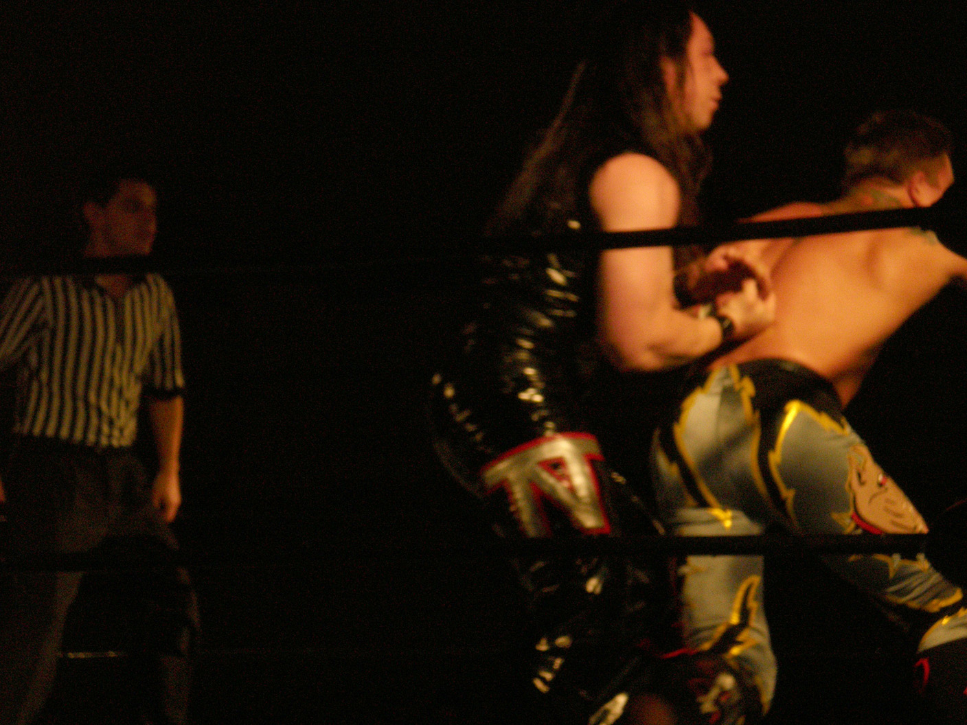 two women fighting each other in a ring