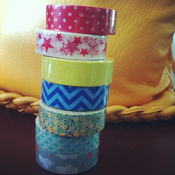 colorful washi tapes stacked together in front of a pillow