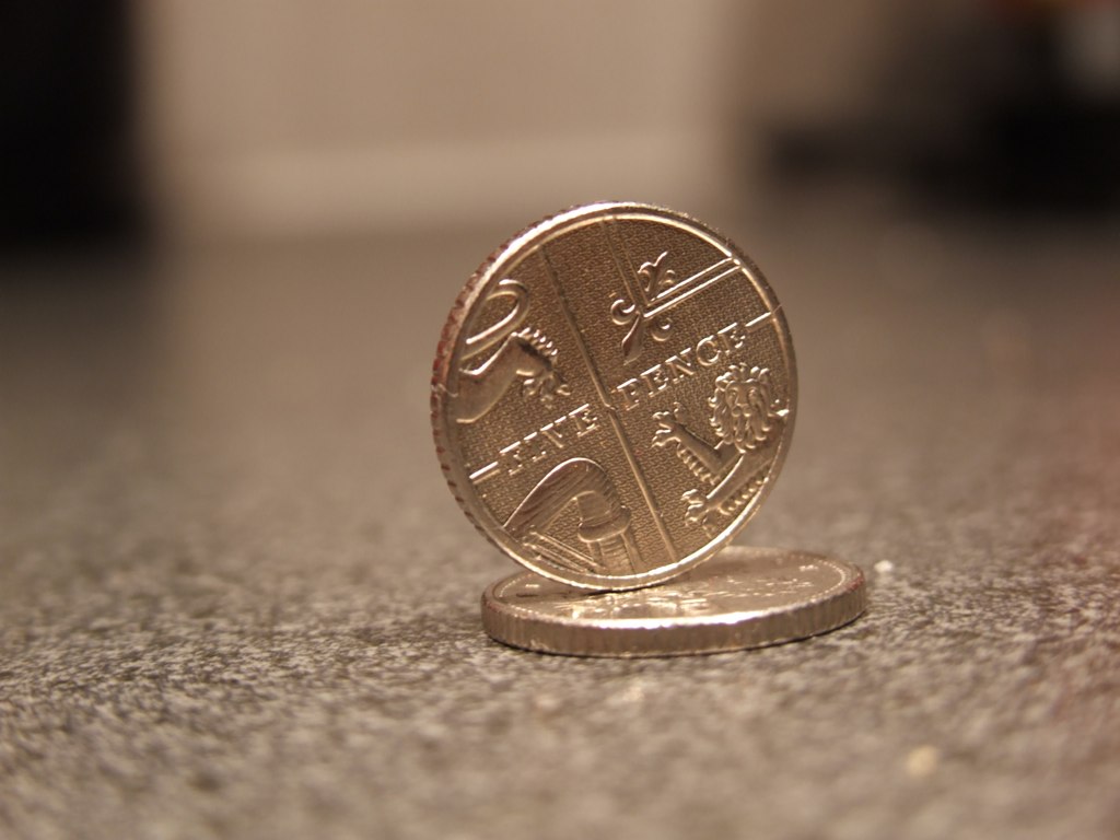 a one pound coin on a counter top