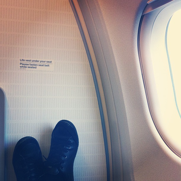 a pair of boots sitting in the corner of an airplane