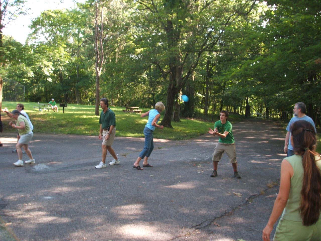 a group of young men playing frisbee in the park