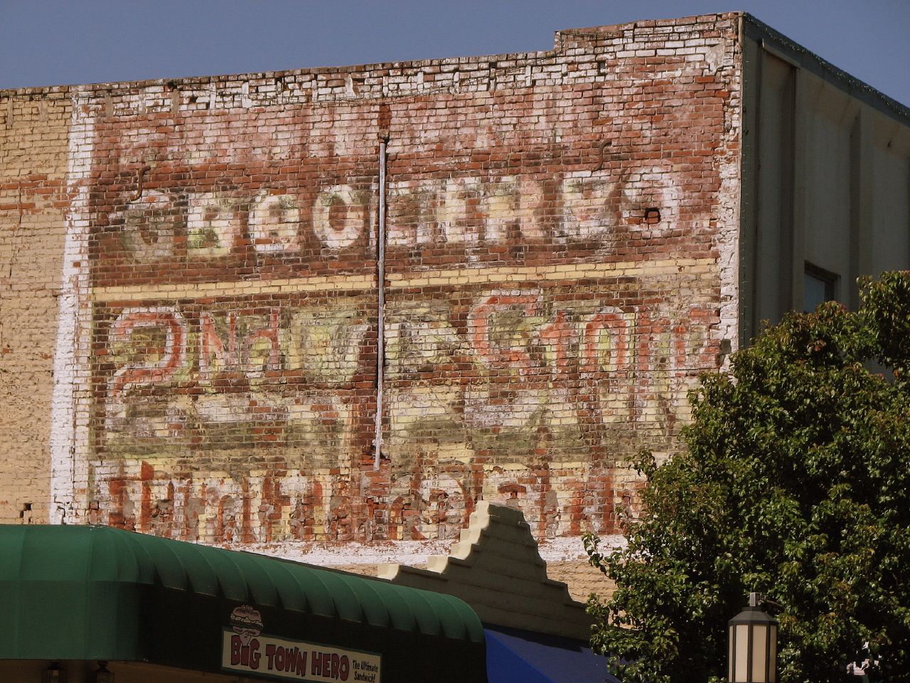 there is an old advertising sign on the building