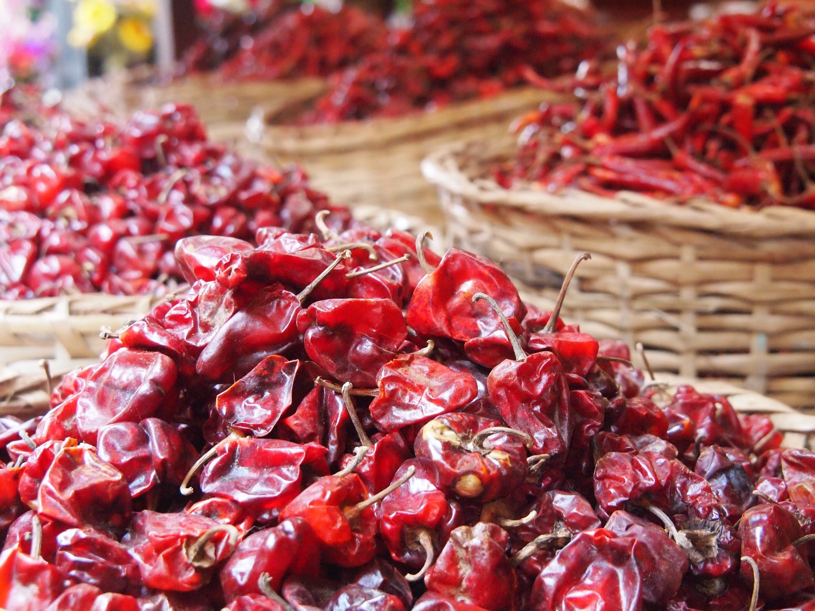 baskets of cranberries are stacked in rows with the tops covered by licoras