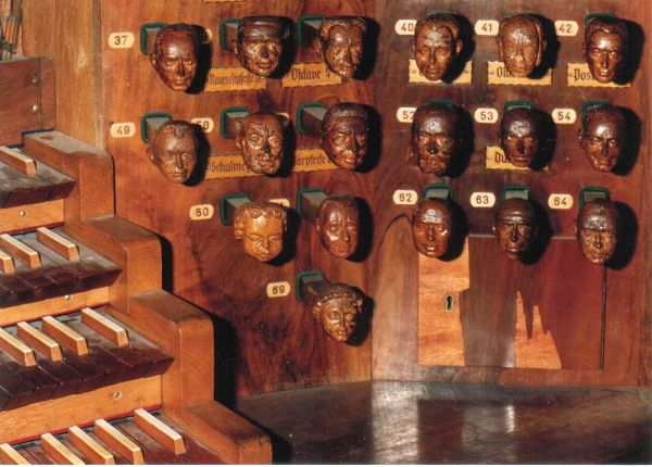 an artistic display of wooden faces and musical keyboards