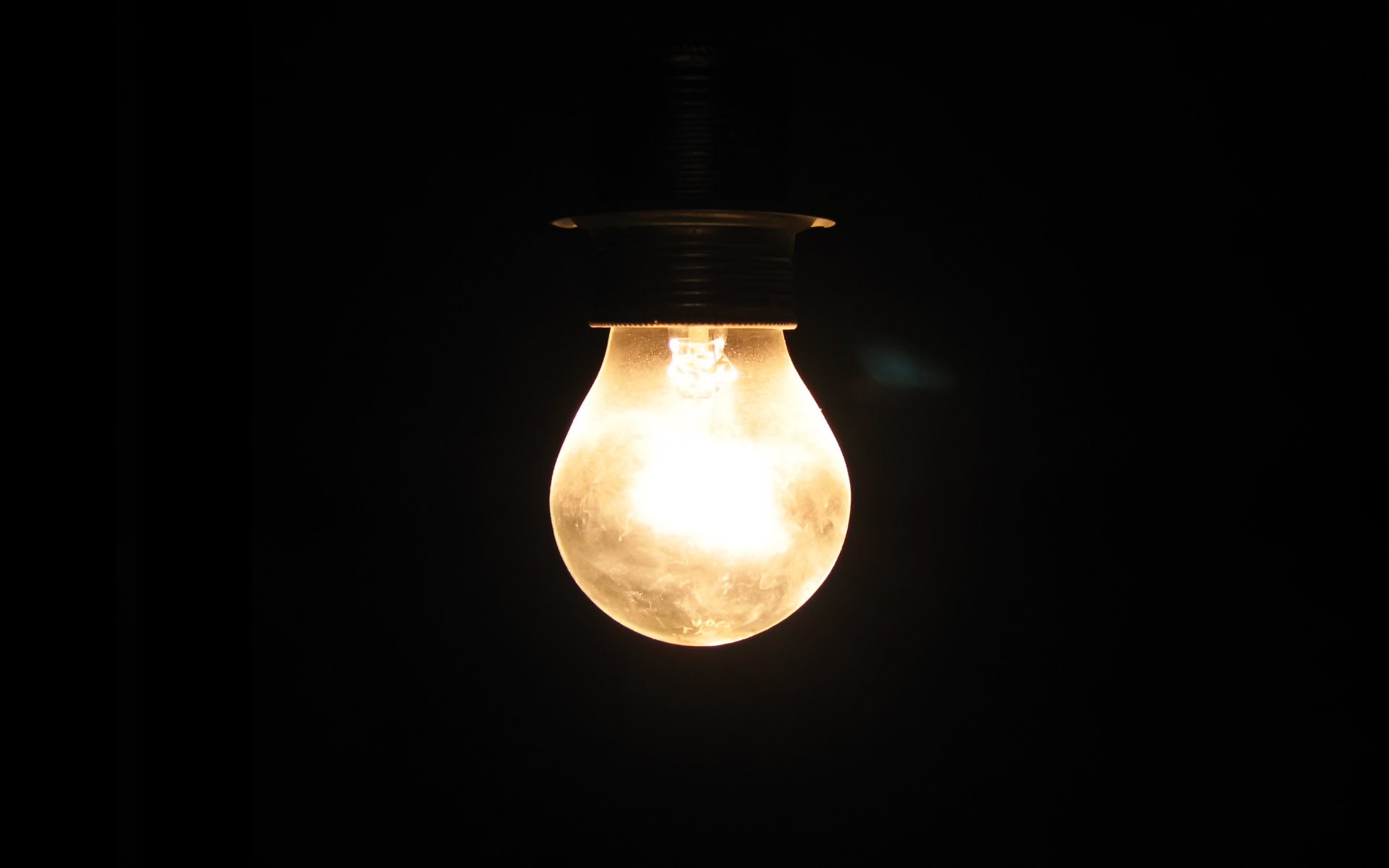 a light bulb that is shining on the dark