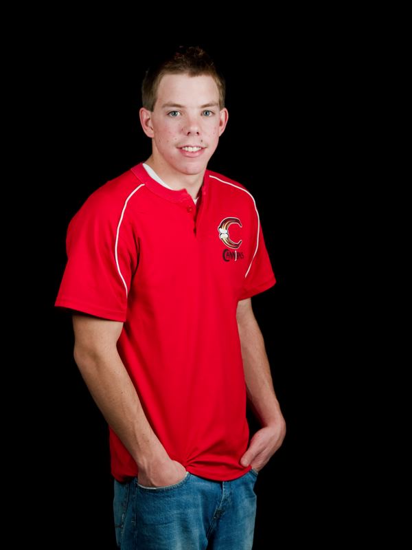 young man in a red polo shirt posing for a po