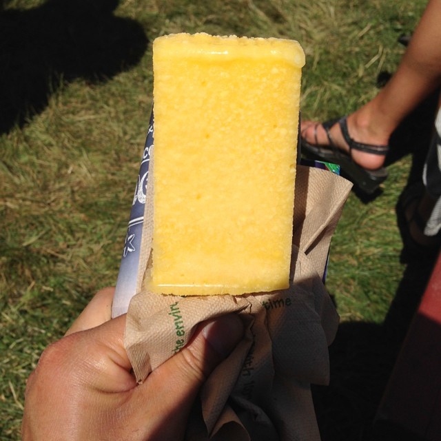 a person holding onto a yellow block of soap