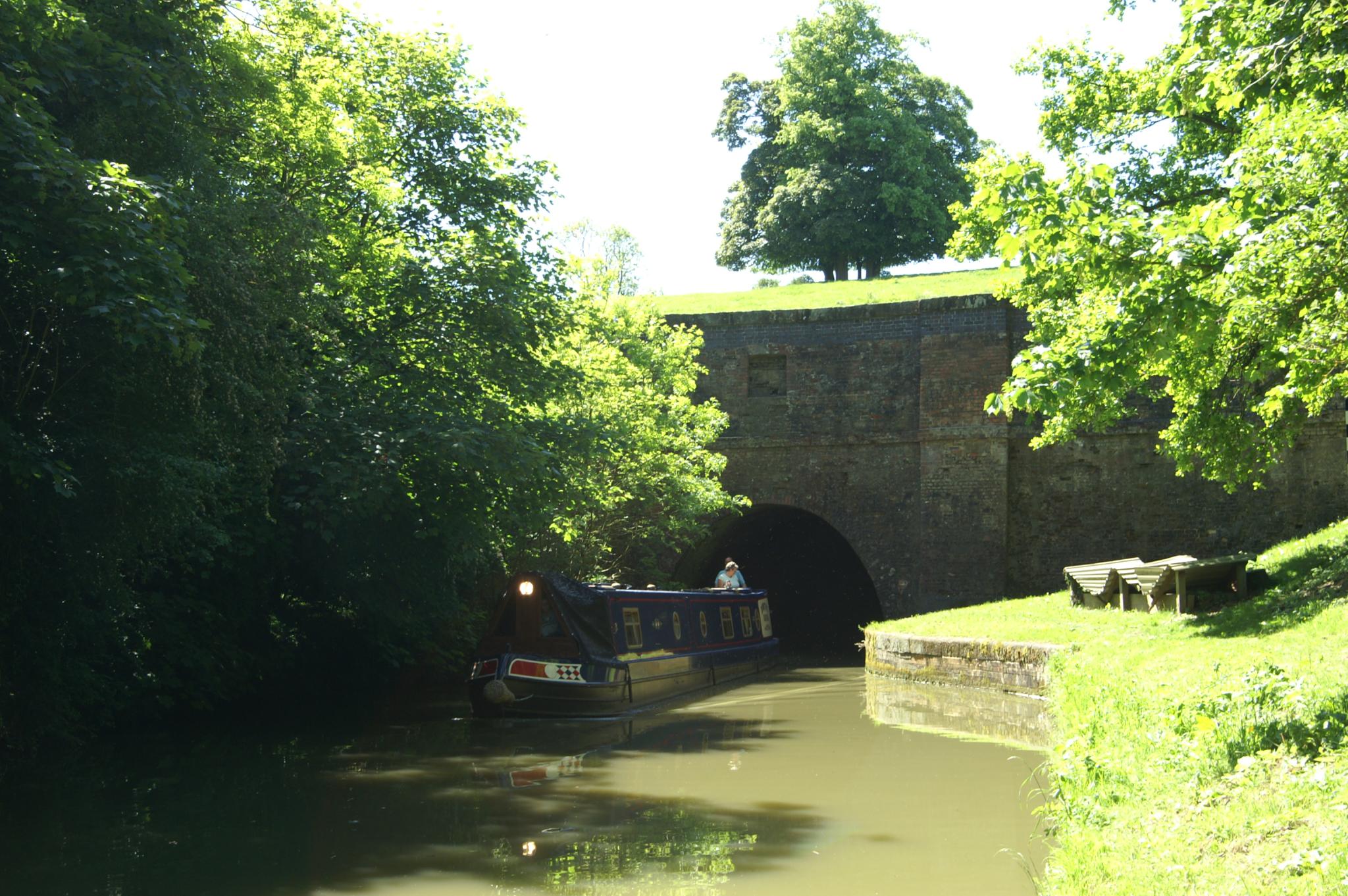 a small boat traveling out into a tunnel