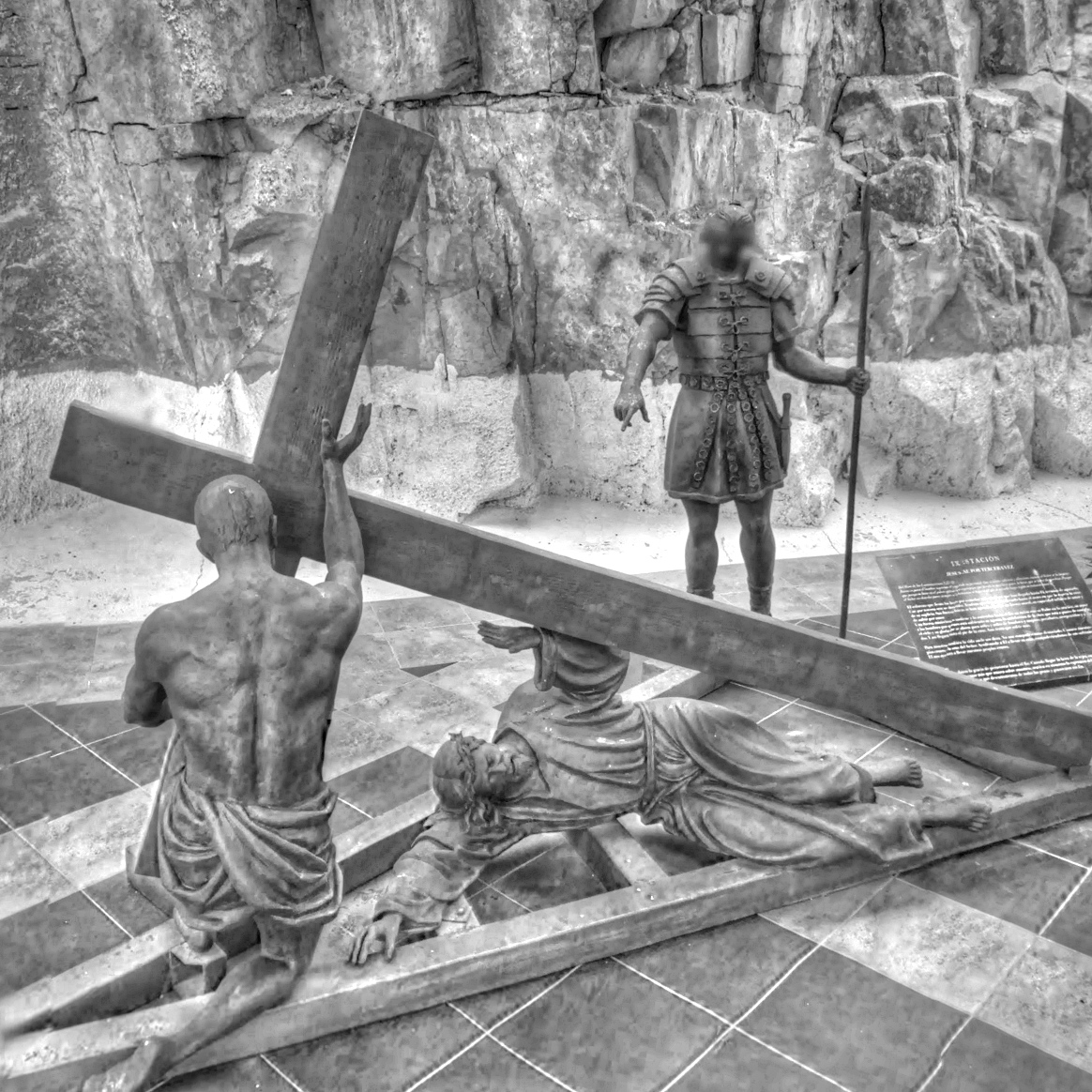 a cross being lowered onto a stone platform