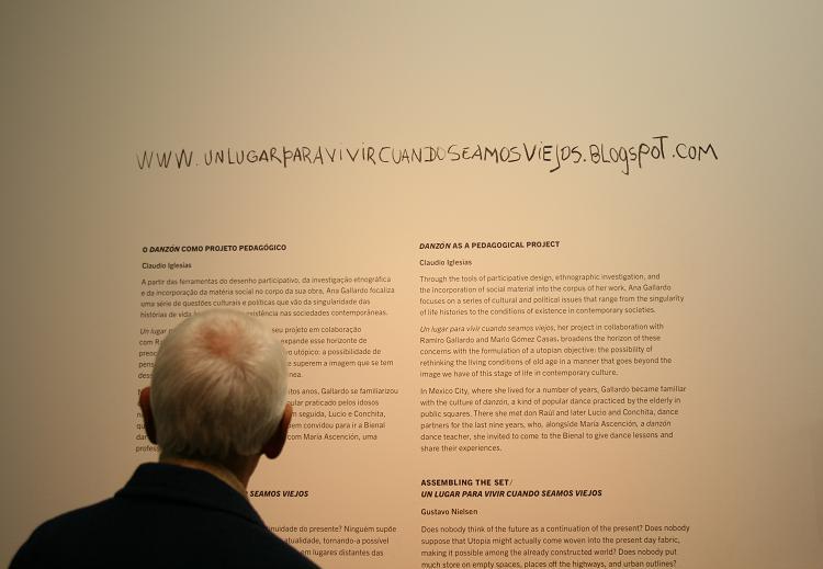 a man looking at a wall with words written