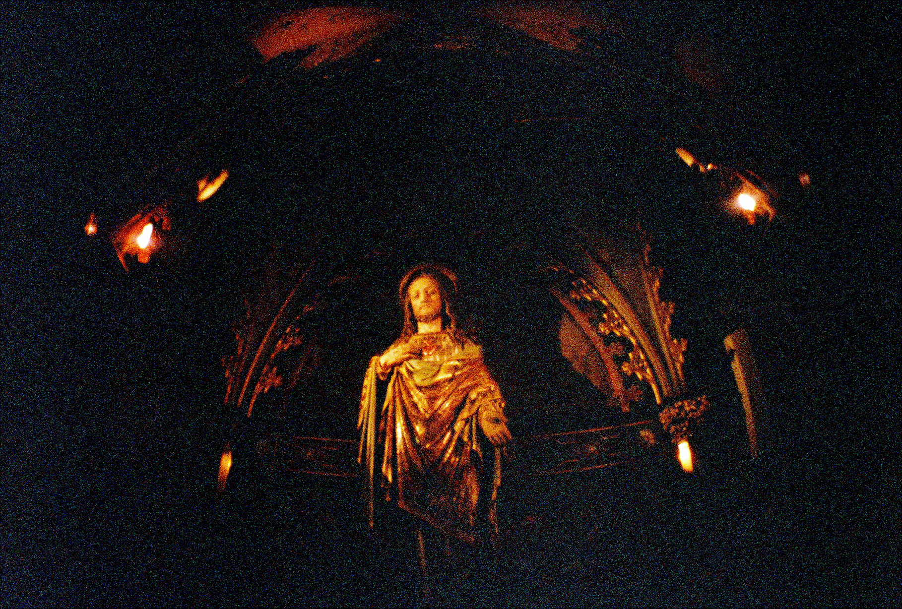 a woman dressed in gold on a platform in the dark