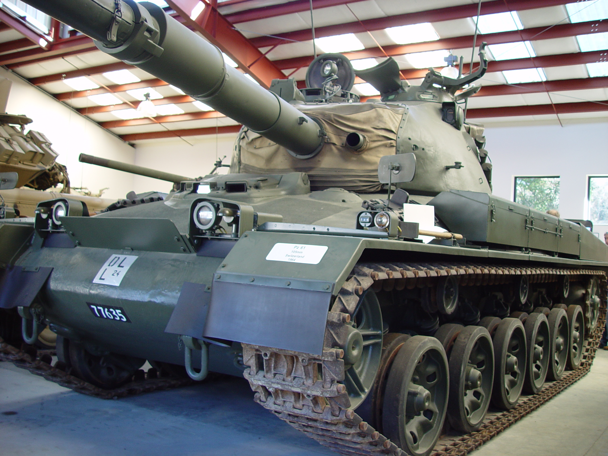 an old tank sits in the middle of an indoor building