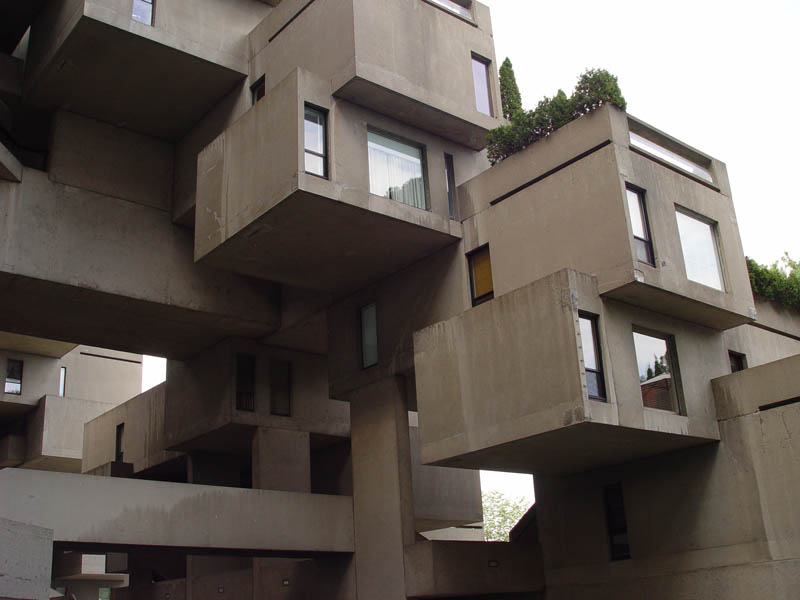 a tall building with many balconies attached