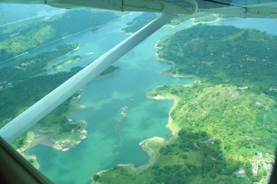 an airplane flies over the water and land