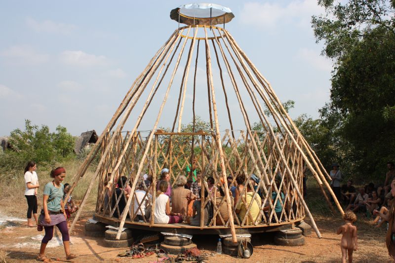 people are gathered around a large group building